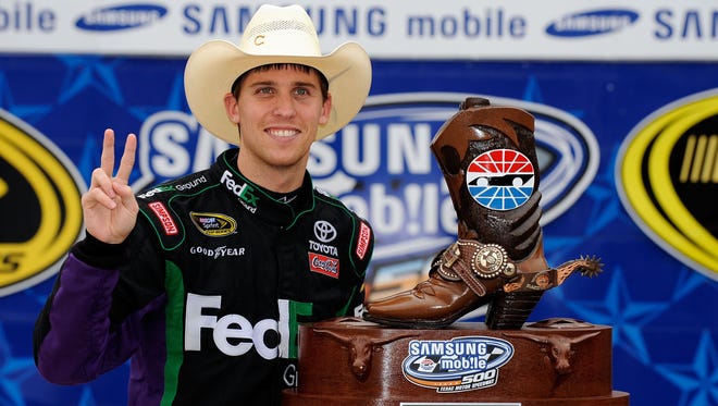 Denny Hamlin poses with the trophy in victory lane after he won the Samsung Mobile 500 at Texas Motor Speedway on April 19, 2010, for his 10th career Sprint Cup win.