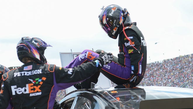 Denny Hamlin gets out of his car through a customized roof hatch during the first caution of the 2013 Aaron's 499 at Talladega Superspeedway on May 5. Brian Vickers took over driving the No. 11 Toyota in Hamlin's first race back from injury.