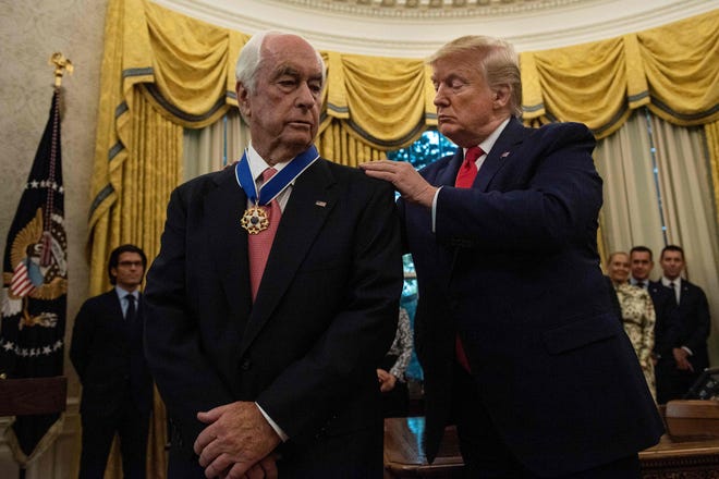 US President Donald Trump and Roger Penske(L) speak during his Presidential Medal of Freedom ceremony in the Oval Office of the White House October 24, 2019, in Washington, DC. (Photo by Brendan Smialowski / AFP) (Photo by BRENDAN SMIALOWSKI/AFP via Getty Images) ORIG FILE ID: AFP_1LP8GU