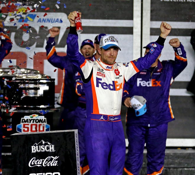 Denny Hamlin celebrates after winning his second consecutive Daytona 500 and third of his career on Feb. 17, 2020.