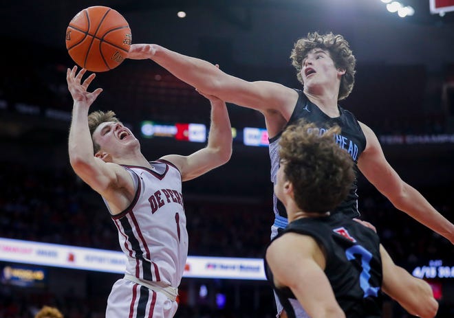 De Pere High School's John Kinziger (1) falls to the floor after being fouled by Arrowhead High School's Alex Kramer (2) during the WIAA Division 1 boys basketball state championship game on Saturday, March 18, 2023, at the Kohl Center in Madison, Wis. De Pere won the game, 69-49, to finish the season a perfect 30-0.
Tork Mason/USA TODAY NETWORK-Wisconsin