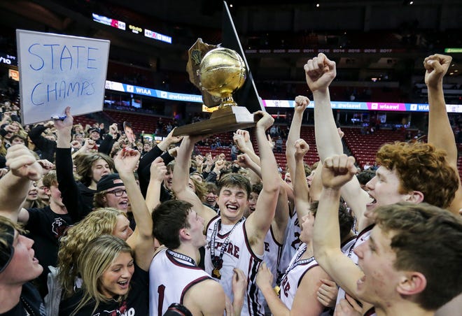 De Pere High School's Gabe Herman (2) holds up the state championship trophy as he and his teammates celebrate with the De Pere student section during the WIAA Division 1 boys basketball state championship game on Saturday, March 18, 2023, at the Kohl Center in Madison, Wis. De Pere defeated Arrowhead High School, 69-49, to finish the season a perfect 30-0.
Tork Mason/USA TODAY NETWORK-Wisconsin