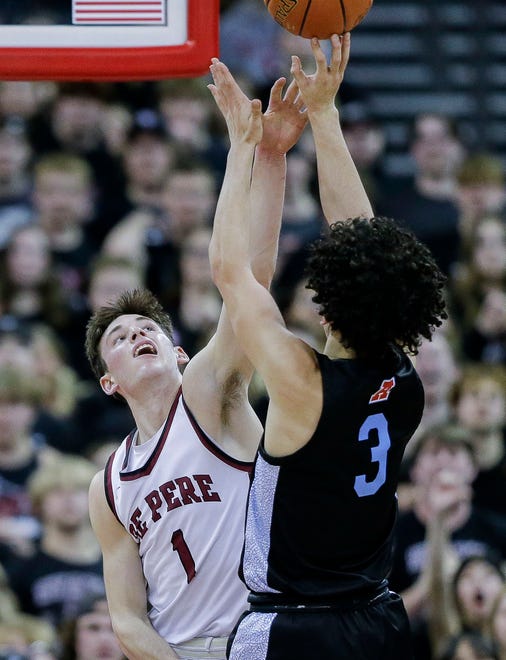 De Pere High School's John Kinziger (1) contests a shot by Arrowhead High School's Austin Villarreal (3) during the WIAA Division 1 boys basketball state championship game on Saturday, March 18, 2023, at the Kohl Center in Madison, Wis. De Pere won the game, 69-49, to finish the season a perfect 30-0.
Tork Mason/USA TODAY NETWORK-Wisconsin