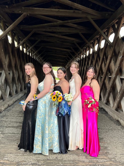 Nicolet High School students Lila Bangert-Pakroo, Maddie Weinberg, Ava Blair, Bella Luderitz and Hjordis Bianchini pose for a photo at the Cedarburg Bridge before their prom on Saturday, April 27, 2024, at the River Club in Mequon.